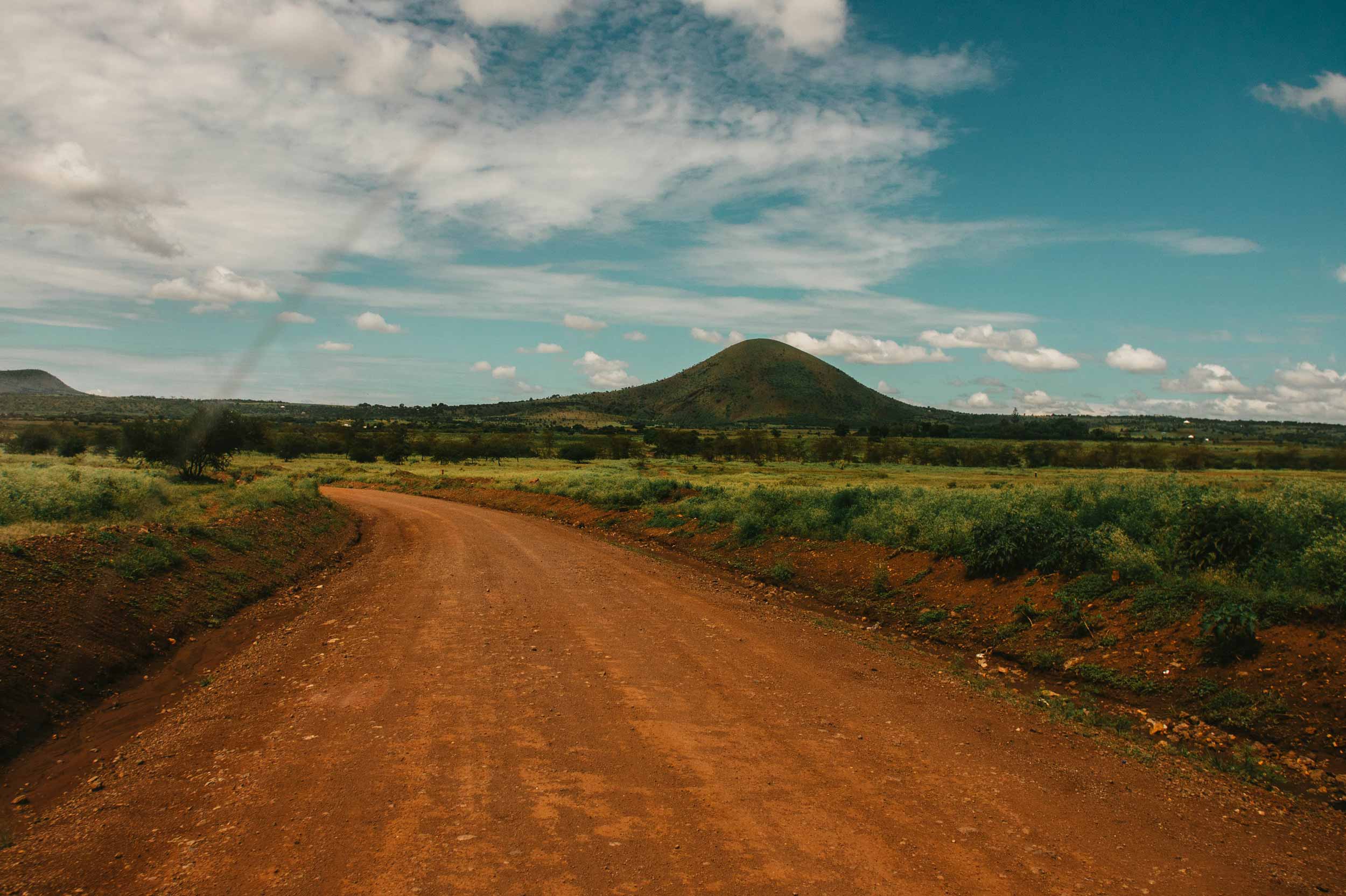 Landscape And A Dirtroad In Tanzania With A Hill In The Background
